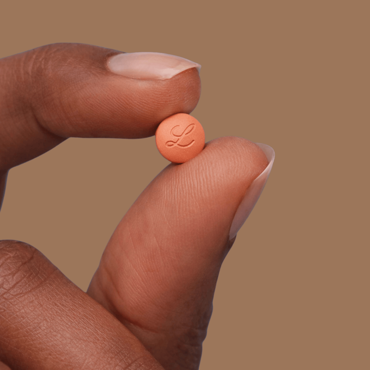 Foundayo hand holding pill